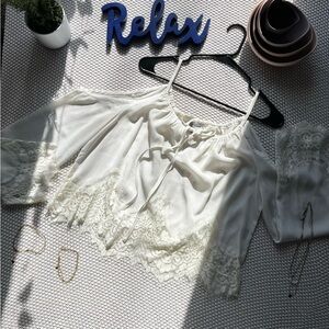 White, off the shoulder, sheer and lace top with elbow length arms.